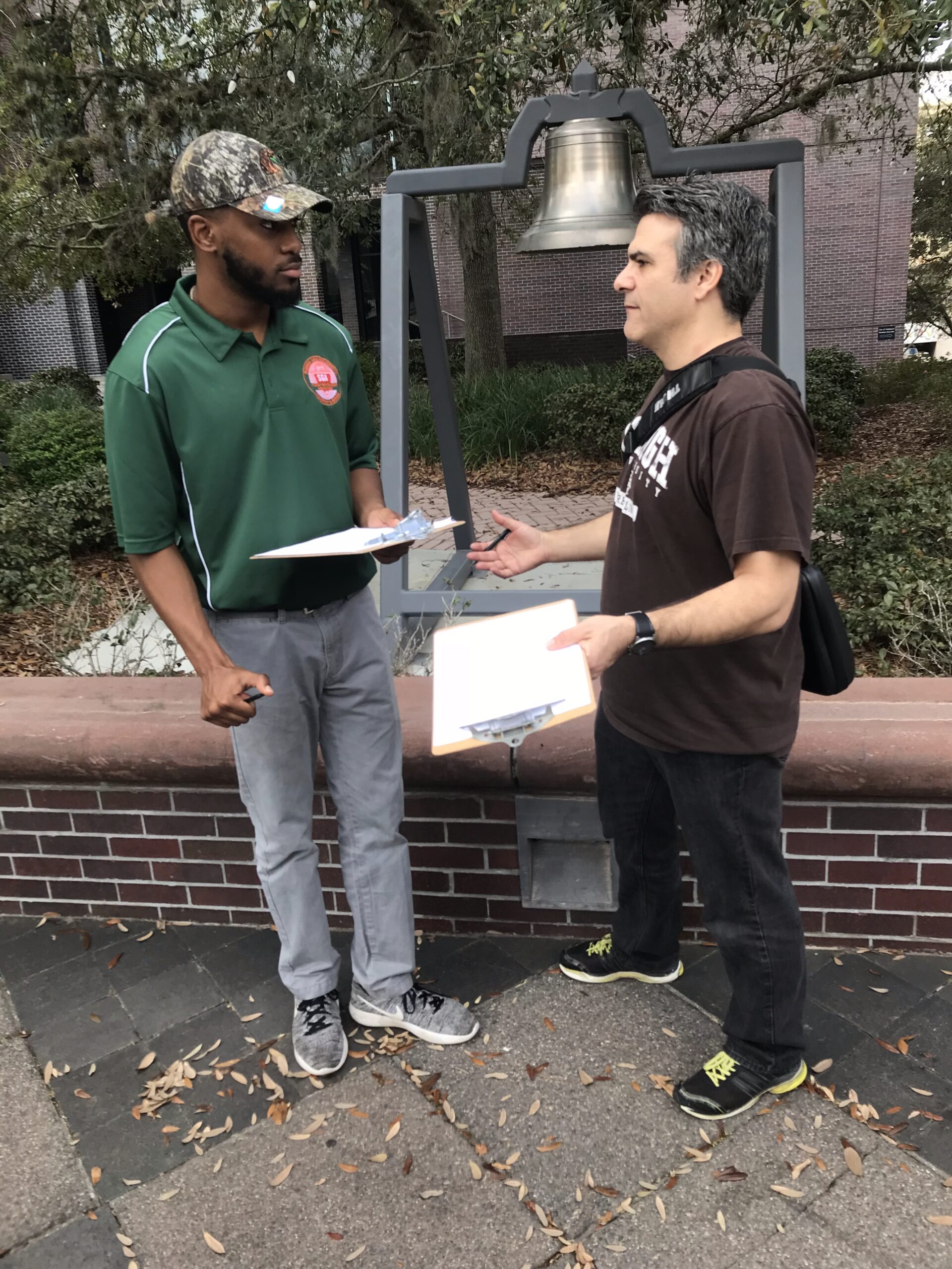 Craig Grella training a volunteer on how to gather signatures during a rally